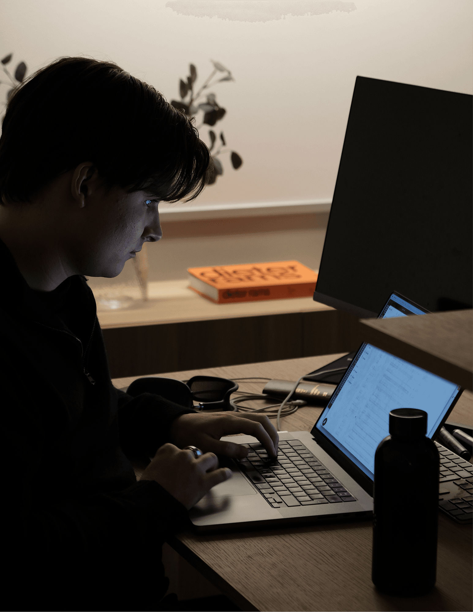 A Scape teammate working at a laptop.